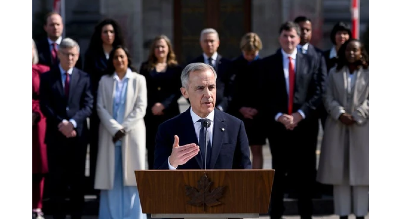 Mark Carney, Canada's prime minister, center, speaks to members of the media after a swearing-in ceremony