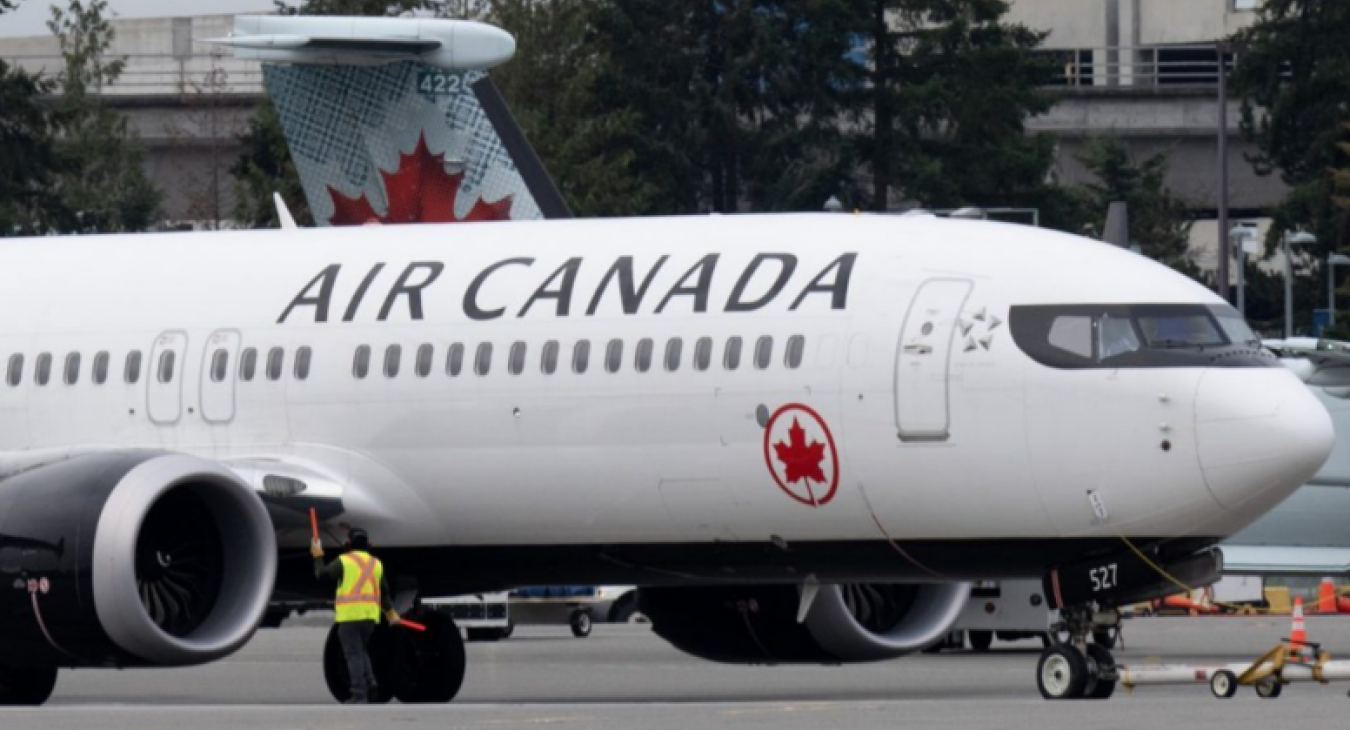 An Air Canada jet is manoeuvred on the tarmac at Vancouver airport 