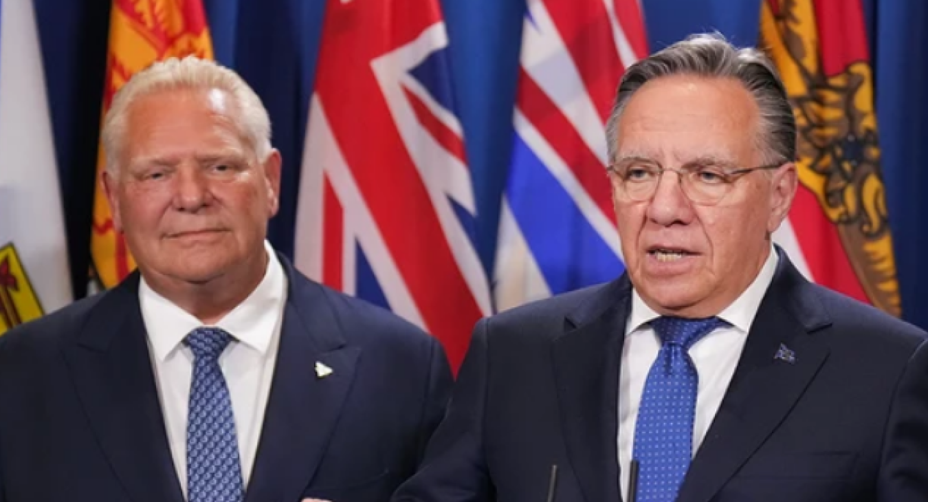 Quebec Premier François Legault, right, speaks to reporters with Ontario Premier Doug Ford during the premiers meetings in Huntsville, Ont., July 22, 2025. 