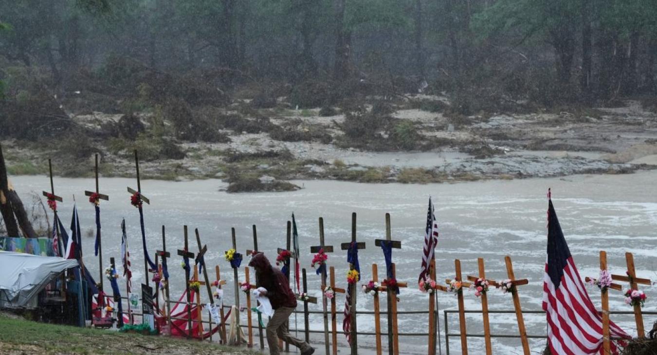 Rain falls over a makeshift memorial for flood victims along the Guadalupe River
