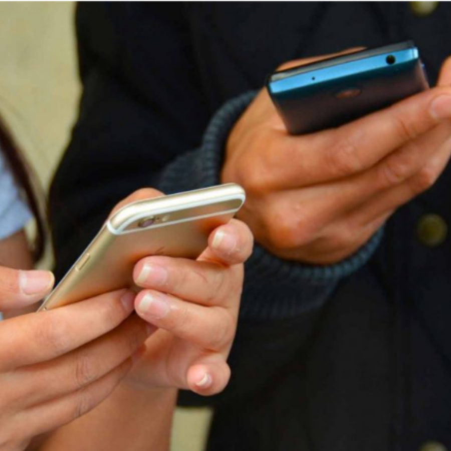File photo of people using cellphones