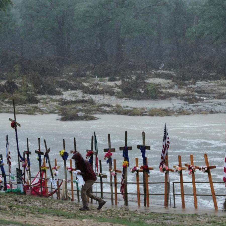 Rain falls over a makeshift memorial for flood victims along the Guadalupe River